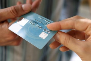 Stock photo of credit card transferring hands