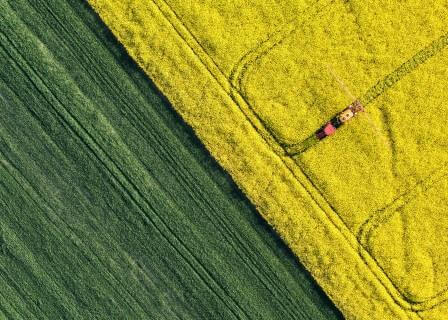 Stock photo depicting bird's eye view of farmer running machine