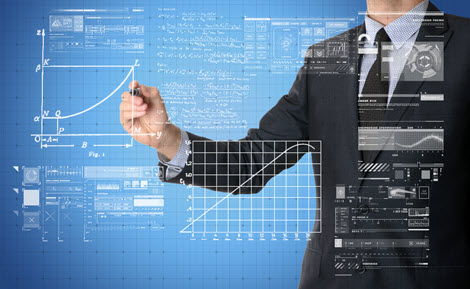 Stock photo of business person drawing numerous graphs and formulas on a clear board
